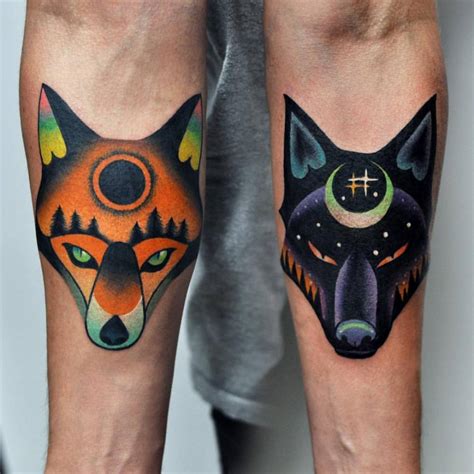 Matching fox and wolf tattoo on both forearms. Done at