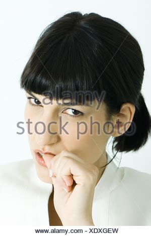 close   woman biting thumb stock photo  alamy