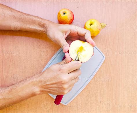 Close up male hands cut an apple into slices. Top view of preparing