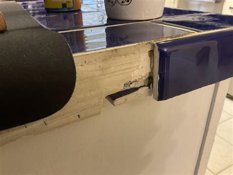 A bullnose tile fell off to reveal previous homeowners used a couple of