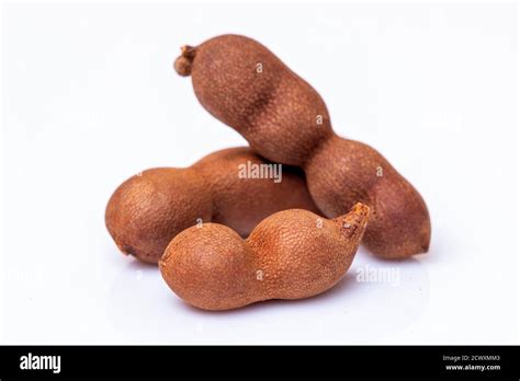 Tamarind fruit pods isolated on a white background Stock Photo - Alamy