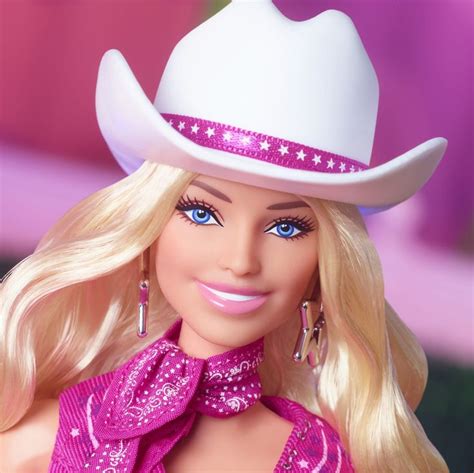 a barbie doll wearing a cowboy hat and pink dress with stars on it's chest