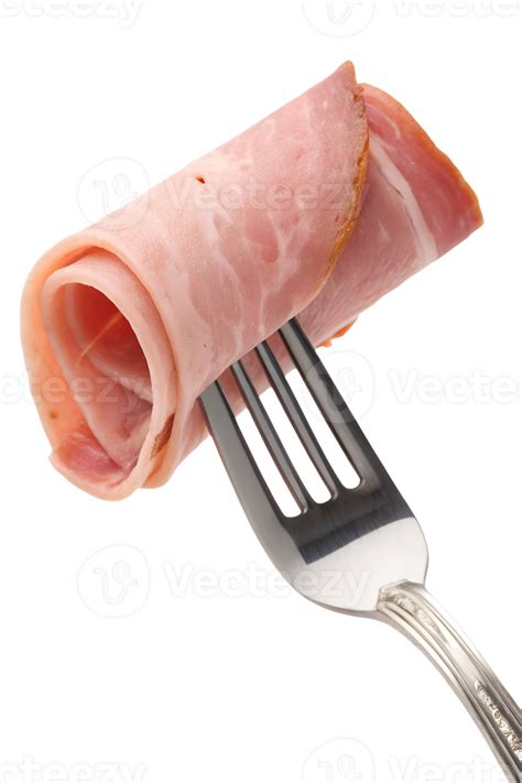 Single slice of rolled deli ham pierced by fork, ready-to-eat protein