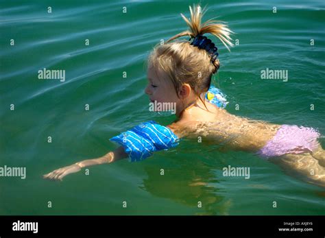 Little girl swimming in the sea Stock Photo - Alamy