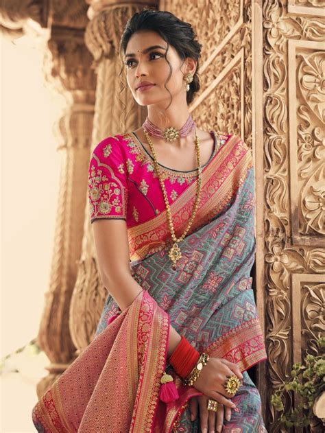 a woman in a pink and blue sari