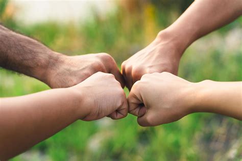 People putting their hands together. Friends making group fist bump
