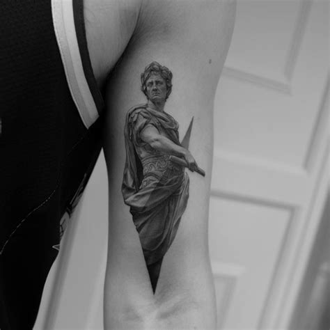Julius Caesar tattoo on the left bicep.