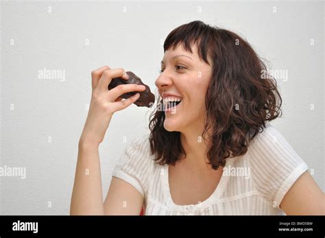 Woman eating chocolate cake Stock Photo - Alamy