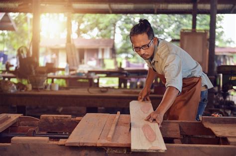 premium photo skilled carpenter cutting  piece  wood