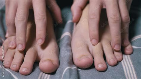 Close up, Child Massages his Tired Feet with his Hands on the Bed in ...