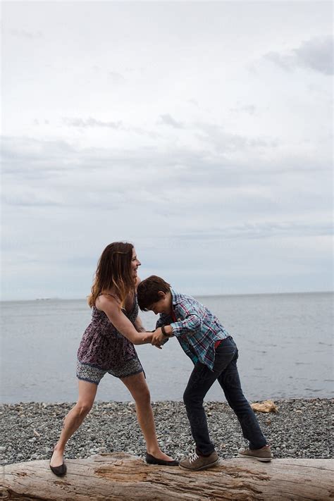 "Mom And Son Spending Time Together Outside In Nature Wrestling" by