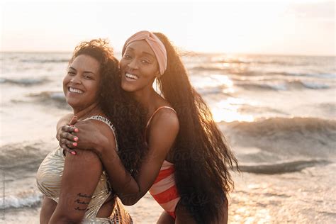 "Two African American Female Friends Swimming And Laughing At The Beach ...