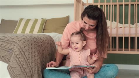 Little girl reading a book in bed Stock Video Footage - 4K and HD Video ...