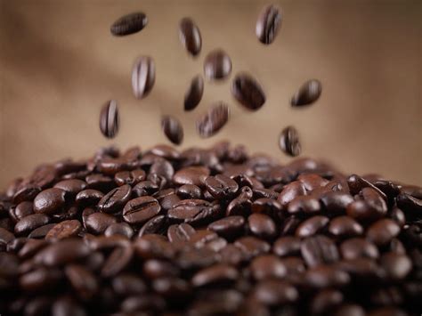 Close Up Of Coffee Beans Falling In Heap by Adam Gault