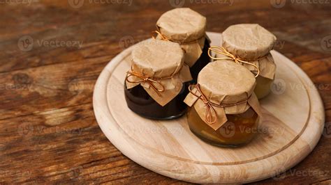 Four glass jars with different kinds of jam on wooden table. Homemade jam 6073954 Stock Photo at ...