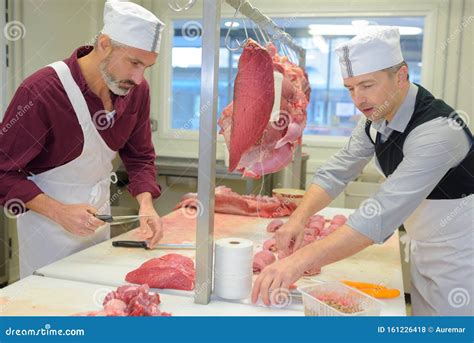 Two Butchers Cutting Meat In Butchery Royalty-Free Stock Image ...