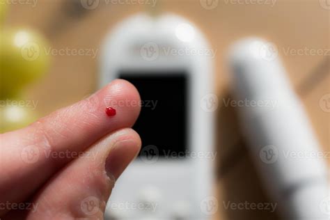 Woman pricking her finger to check blood glucose level with glucometer