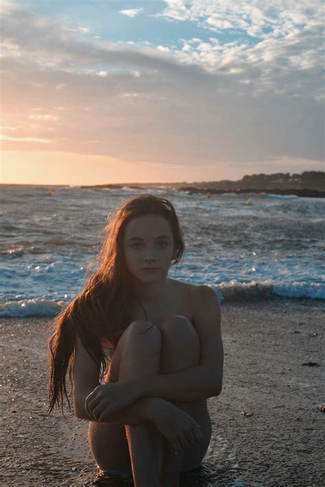 topless woman sitting  beach  sunset photo  beach image