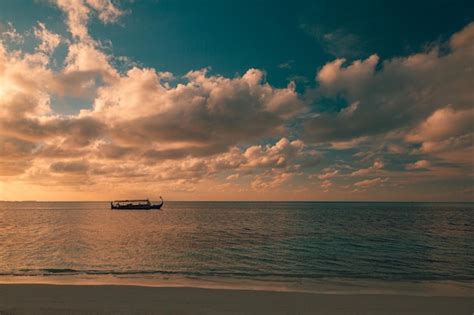 Premium Photo | Maldives sunset cruise with dhoni boat in maldives islands tropical sea sunset ...