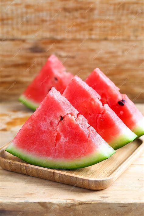 photo fresh sliced watermelon  wooden background