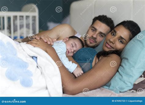 Family snuggles in bed stock image. Image of caring, female - 67692723